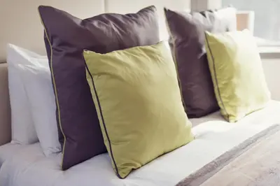 a group of pillows on a bed at Abbey House Hotel in Barrow in Furness