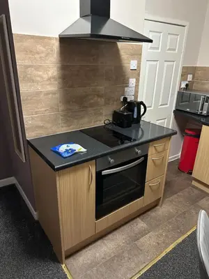 a kitchen with a counter and a stove top oven at Blackpool Beach Holiday Flats in Blackpool