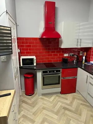 a kitchen with red brick walls and a counter top at Blackpool Beach Holiday Flats in Blackpool