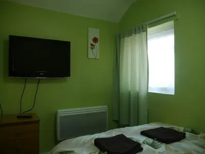 a bedroom with a bed and a television on the wall at Blackpool Beach Holiday Flats in Blackpool