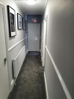 a hallway with a hallway leading to a room with a door at The Braemar Southport in Southport