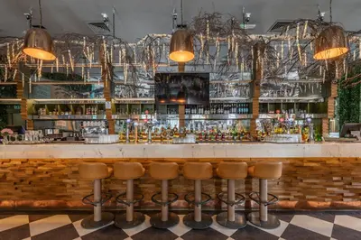 a bar with stools in front of a counter at The Sir Thomas Hotel in Liverpool