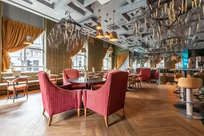a restaurant with pink chairs and tables in a room at The Sir Thomas Hotel in Liverpool