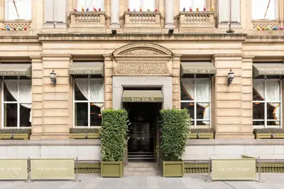 a building with a door and plants in front of it at The Sir Thomas Hotel in Liverpool