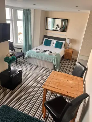 a hotel room with a bed and a table at The Oxfordshire in Blackpool