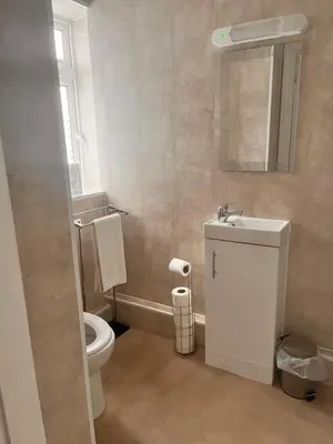 a bathroom with a toilet and a sink and a mirror at The Oxfordshire in Blackpool