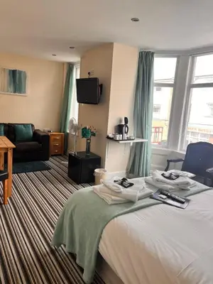 a hotel room with a bed and a couch at The Oxfordshire in Blackpool