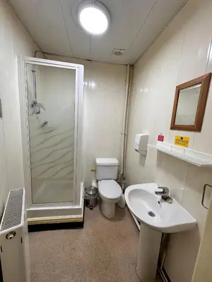 a bathroom with a shower and a toilet and a sink at Throstles Nest Hotel in Liverpool