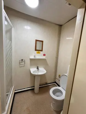a bathroom with a toilet and a sink at Throstles Nest Hotel in Liverpool