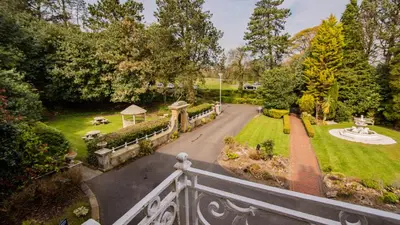 an aerial view of a garden with a white fence at Astley Bank Hotel in Darwen