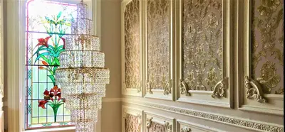a dining room with a chandelier and a window at Astley Bank Hotel in Darwen