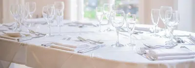 a table with wine glasses and napkins on it at Astley Bank Hotel in Darwen
