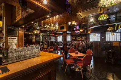 a bar with chairs and tables in a restaurant at Scarisbrick Hotel in Southport