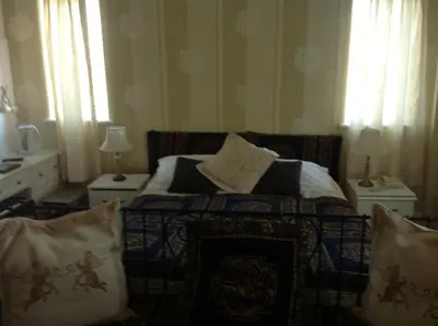 a bedroom with a bed with pillows on it at Balmoral Lodge Hotel in Southport