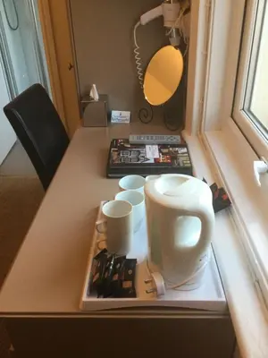 a table with cups on a tray on top of it at The Windsor Carlton in Blackpool