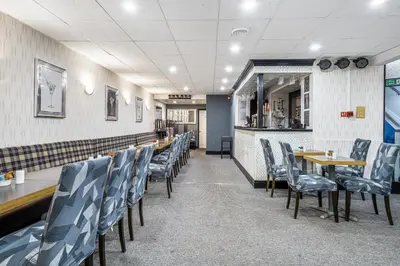 a row of chairs and tables in a restaurant at Bluewaters Hotel, Blackpool North Promenade in Blackpool