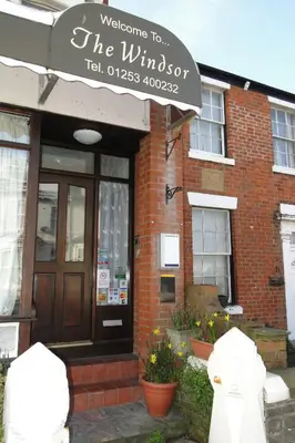 a building with a sign that reads welcome to the wilson tea dispensary at Windsor Hotel in Blackpool