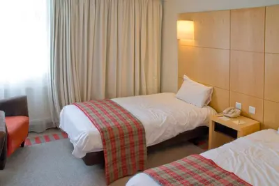 a hotel room with two beds and a telephone at Britannia Hotel Bolton in Bolton