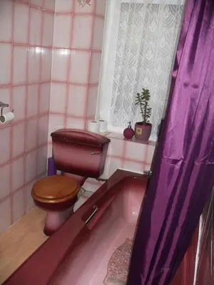 a bathroom with a toilet and a bath tub at Bradleys Hotel in Blackpool