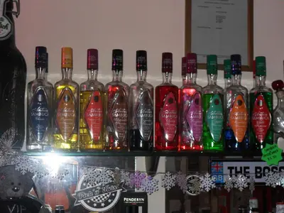 a group of bottles of alcohol on a shelf at Bradleys Hotel in Blackpool