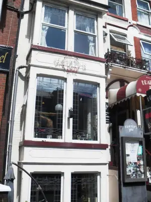 a white building with windows on a city street at Bradleys Hotel in Blackpool