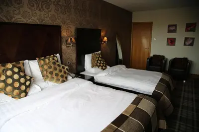 a hotel room with two beds in a room at Inn On The Prom At The Fernlea Hotel in Lytham St Annes