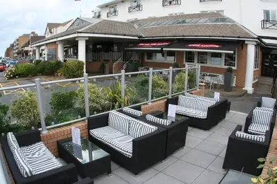 a group of benches sitting in front of a building at Inn On The Prom At The Fernlea Hotel in Lytham St Annes