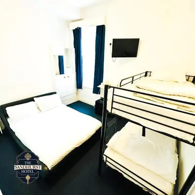 a room with two bunk beds and a television at The Sandhurst Hotel in Blackpool
