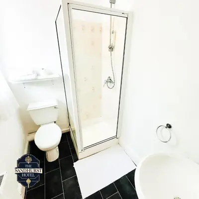 a bathroom with a shower and a toilet at The Sandhurst Hotel in Blackpool
