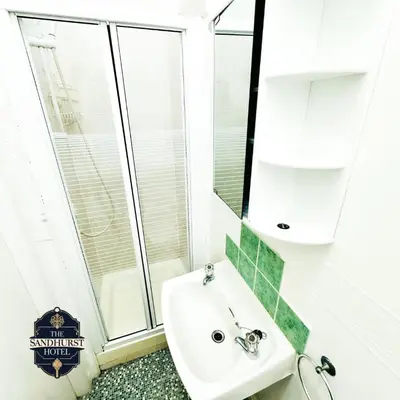 a bathroom with a sink and a mirror at The Sandhurst Hotel in Blackpool