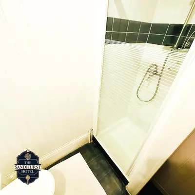 a bathroom with a shower and a toilet at The Sandhurst Hotel in Blackpool