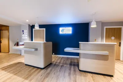 a room with two counters and a blue wall at Holiday Inn Express - Wigan by IHG in Wigan