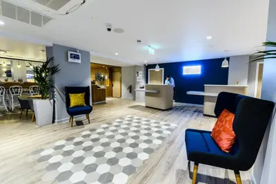 a lobby with two chairs and a rug at Holiday Inn Express - Wigan by IHG in Wigan