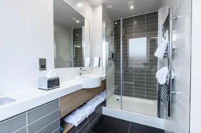 a bathroom with a sink and a shower at Holiday Inn Express - Wigan by IHG in Wigan