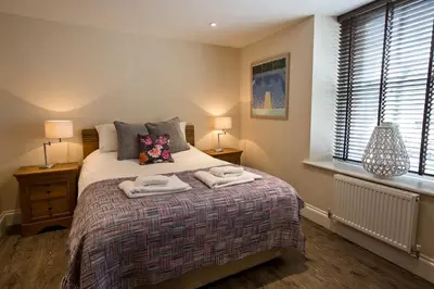 a bedroom with a bed with towels on it at Cider House in Ulverston