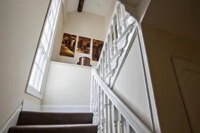 a staircase with white railings in a house at Cider House in Ulverston