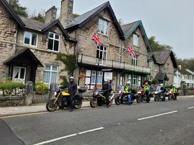 a group of people on motorcycles parked in front of a building at Elton Guest House in Grange Over Sands