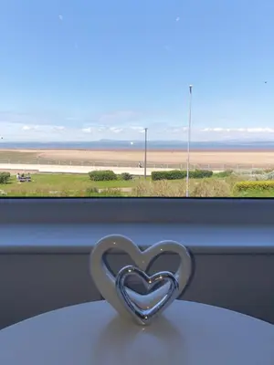 a heart shaped metal object sitting on a window sill at Balmoral in Morecambe