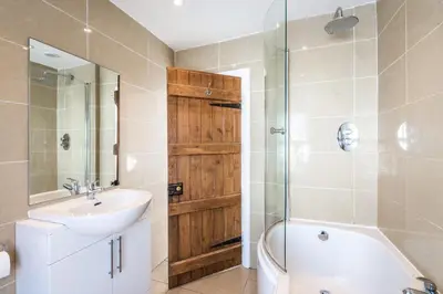 a bathroom with a sink and a toilet and a shower at Lobster Cottage Lytham in Lytham St Annes
