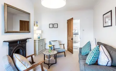 a living room with a couch and a fireplace at Lobster Cottage Lytham in Lytham St Annes