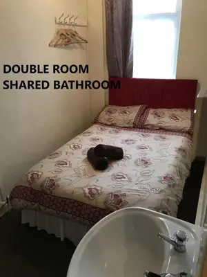 a bathroom with a bed with a sink and a tub at Coco Beach Hotel in Blackpool