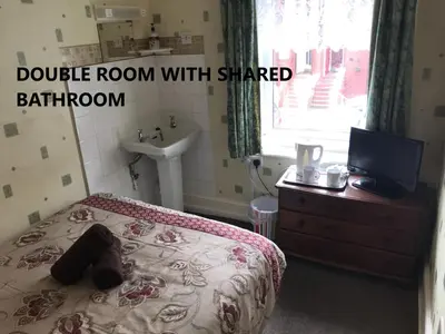 a bedroom with a bed with a sink and a sink at Coco Beach Hotel in Blackpool