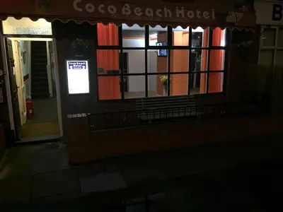 a building at night with a sign in the window at Coco Beach Hotel in Blackpool