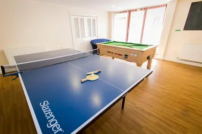 a ping pong table in a living room with a table top at Dalmeny Hotel in Lytham St Annes