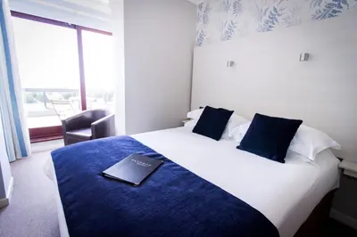 a hotel room with a bed with a book on it at Dalmeny Hotel in Lytham St Annes