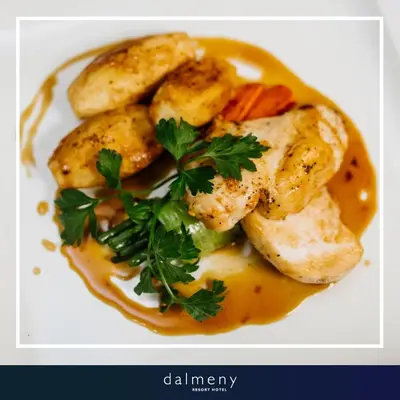 a plate of food with chicken and carrots and gravy at Dalmeny Hotel in Lytham St Annes