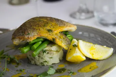 a plate with a fish dish with mashed potatoes and vegetables at Dalmeny Hotel in Lytham St Annes