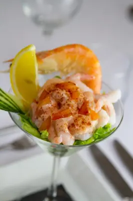 a glass bowl filled with shrimp and a lemon slice at Dalmeny Hotel in Lytham St Annes