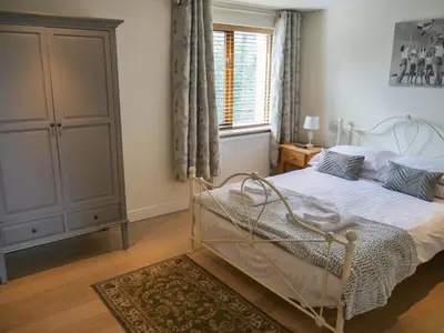 a bedroom with a white bed and a window at Tewitfield Marina in Carnforth