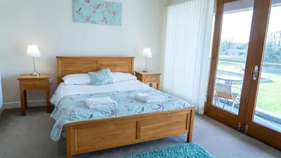 a bedroom with a bed with two towels on it at Tewitfield Marina in Carnforth